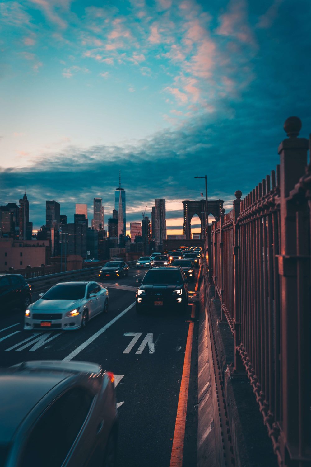 cars on Brooklyn Bridge at sunset