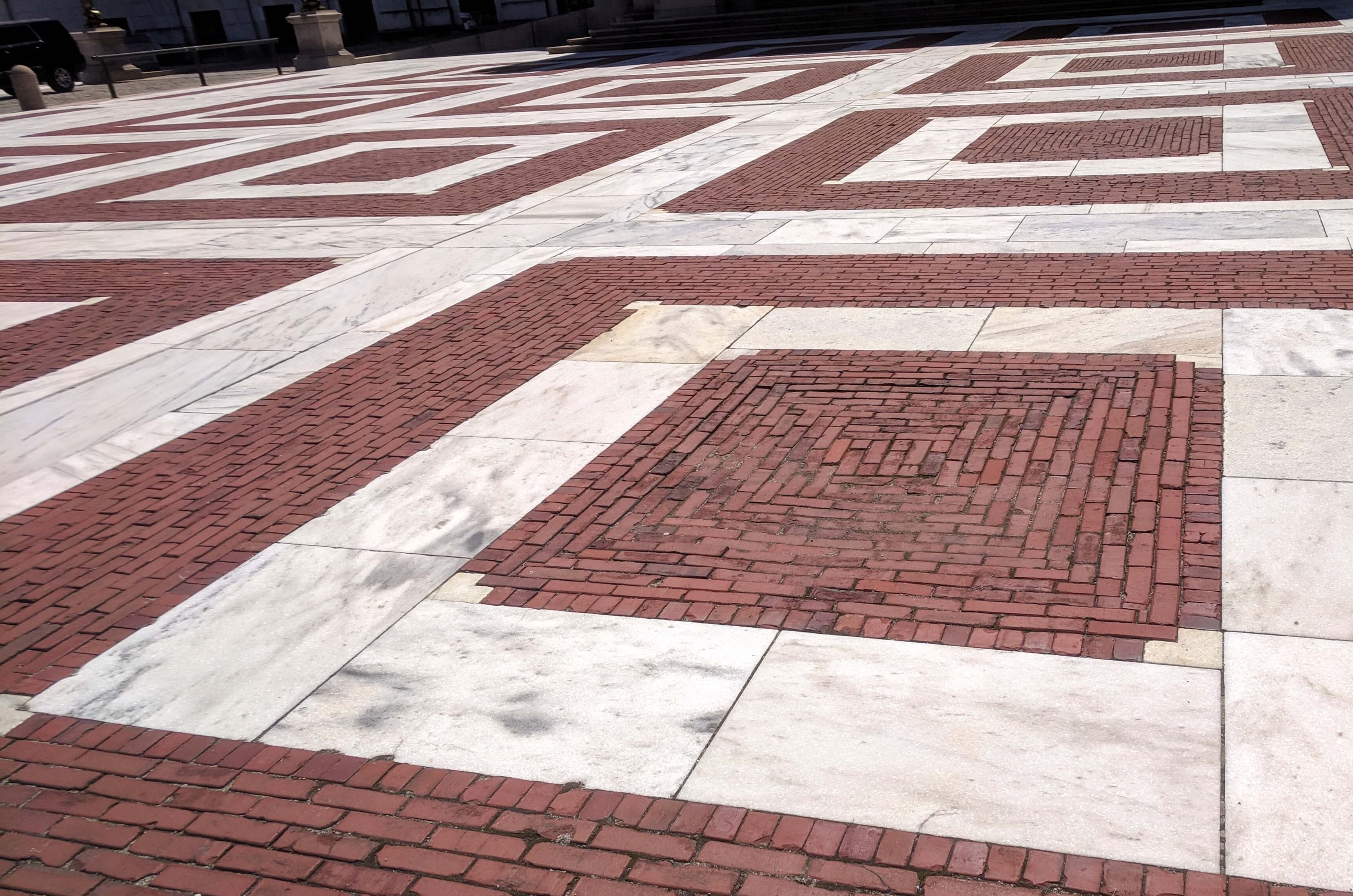 red brick and white marble designs on plaza