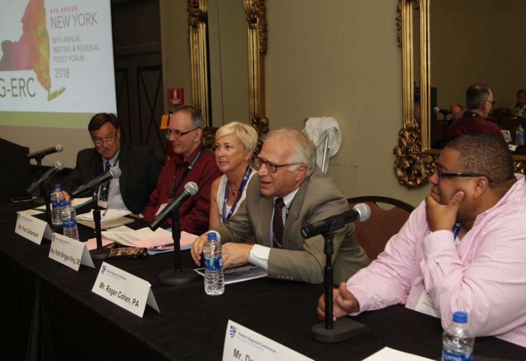 people speaking during a panel discussion