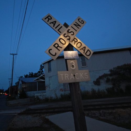 railroad crossing sign at dusk