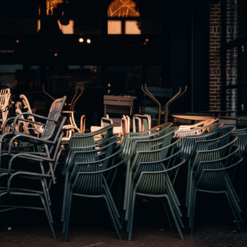 empty chairs stacked in front of restaurant