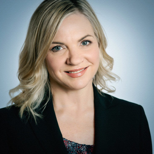 headshot of woman with blonde hair and black blazer